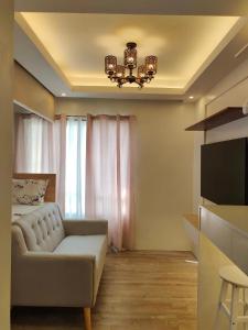 a living room with a couch and a television at Studio Type BNB Accommodation in Bacolod