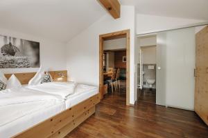a bedroom with a large bed with a wooden frame at Hubertus - Das Landhaus in Kleinarl +35 photos