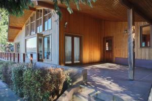 a building with a porch with glass doors on it at Amadeus Hotel Boutique in Frutillar