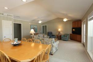 a living room with a table and a couch at One More Time Again by Pristine Properties Vacation Rentals in Mexico Beach