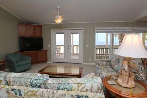 a living room with a couch and a table at One More Time Again by Pristine Properties Vacation Rentals in Mexico Beach
