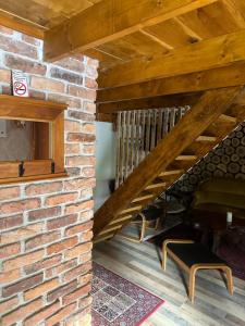 a room with a brick wall and a staircase at Paradise on the Vrbas River in Jajce