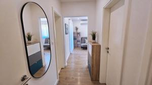 a hallway with a mirror and a hallway with a room at Apartment Zore in Promajna