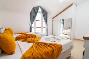a bedroom with two beds with yellow sheets at Villa Angel - Private Pool and Nature View in Ölüdeniz in Fethiye +44 photos
