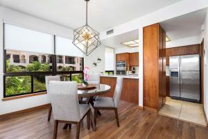 a kitchen and dining room with a table and chairs at The Shores at Waikoloa 231 in Waikoloa