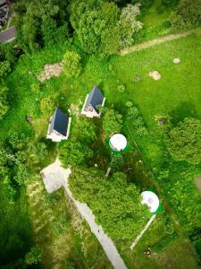 an overhead view of a park with tents and trees at The Frog Glamping in Horezu