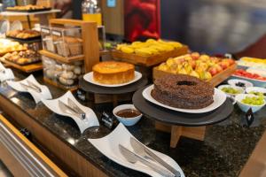 a buffet with a chocolate cake and other desserts at ibis Paulinia in Paulínia
