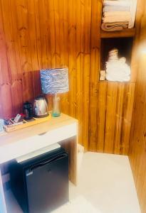 a kitchen with a counter and a wooden wall at Cabin by the coast in Edinburgh