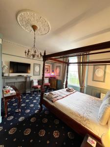 a bedroom with a canopy bed and a living room at Ivybank Villa in Rothesay