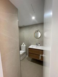 a bathroom with a sink and a toilet and a mirror at Casa Sasera in Colonia Sant Jordi +20 photos