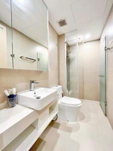 a bathroom with a toilet and a sink and a shower at The Sóng Vũng Tàu - An Gia Apartment in Vung Tau