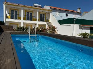 a swimming pool in front of a house at Best Houses 70 - Mariano Loft 1 in Serra de El-Rei