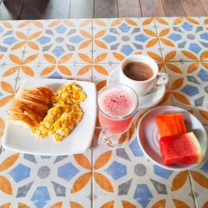 a table with a plate of food and a cup of coffee at casa Hotel la Tranquera in Villa de Leyva