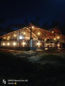 a building lit up at night with lights at Coffee Country Homestay in Chikmagalūr