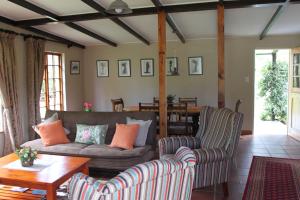 a living room with two chairs and a couch at Cottage Suikerbekkie in Dullstroom