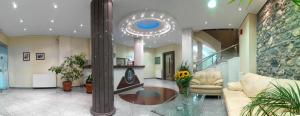 a living room with a couch and a glass table at Alex Hotel in Tripoli