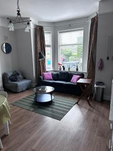 a living room with a couch and a table at Superb Location 3 MIN TO RDS, AVIVA, D4 2 BED APARTMENT in Dublin