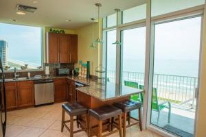a kitchen with a counter with a view of the ocean at 1801 Sapphire Beachfront 3 Bedroom Condo in South Padre Island