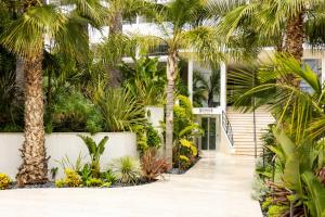 a courtyard with palm trees and a building at Staybridge Suites - Cannes Centre by IHG in Cannes