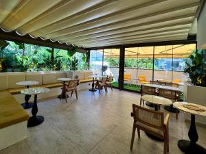 a restaurant with tables and chairs and windows at Coastline in Antalya