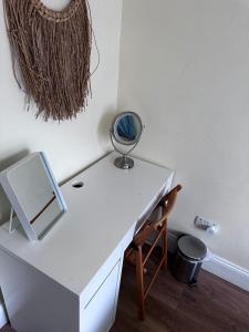 a white desk with a mirror and a chair at Superb Location 3 MIN TO RDS, AVIVA, D4 2 BED APARTMENT in Dublin