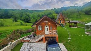 a house with a car parked in front of it at Vilat Pllumaj in Gropat e Selcës