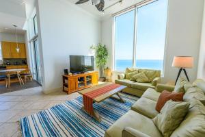 a living room with a couch and a tv at 1901 Sapphire Beachfront 3 Bedroom Condo in South Padre Island