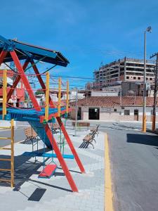 a playground with a red and blue slide at Casinha Vó Cidinha in Aparecida