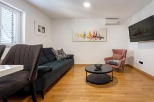 a living room with a couch and a table at Villa Marina in Slano