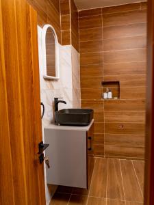 a bathroom with a sink on a counter and a mirror at Appartement Ibiza in Cotonou