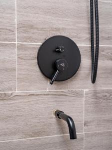 a black table on a tile floor with a faucet at Appartement Ibiza in Cotonou +15 photos