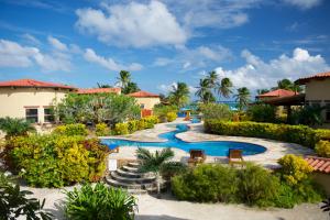 ein Resort mit einem Pool mit Stühlen und Bäumen in der Unterkunft Villa Serenity in San Pedro