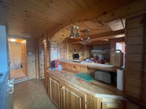 a kitchen with a large counter in a cabin at Alpenperle Studio in Riederalp
