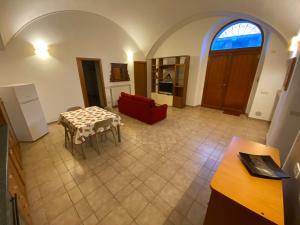 a living room with a table and a red couch at Casa Sant’Anna in Vasto