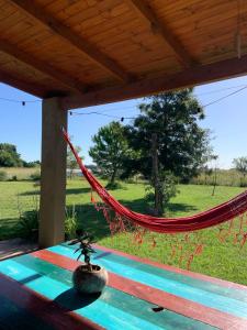 a hammock on a porch with a view of a field at Casa rústica in San Pedro +12 photos