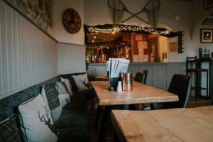 a dining room with two tables and a bar at Troutbeck Inn in Troutbeck