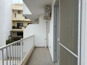 a hallway of a building with a stairway at Mediterranean Nest in Is-Swieqi