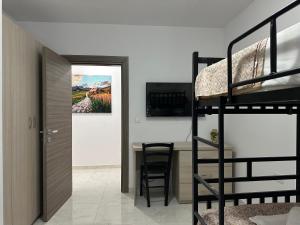 a room with a bunk bed and a dining room with a table at Mediterranean Nest in Is-Swieqi