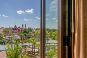 a window with a view of a city at Cartesiano Boutique & Wellness Hotel in Puebla