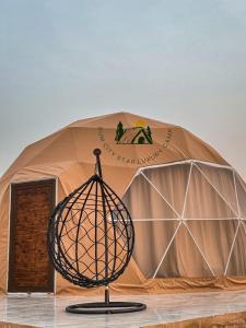 a dome tent with a cage in front of it at Rum city Star LUXURY Camp in Wadi Rum