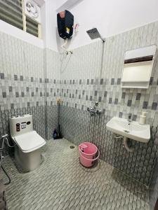 a bathroom with a toilet and a sink at LOFTEL STAYS in Hyderabad +18 photos