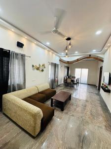 a living room with a couch and a table at LOFTEL STAYS in Hyderabad
