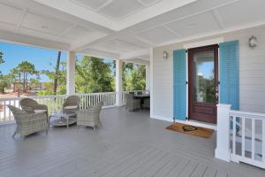 a porch with chairs and a table on a house at Brise Del Mar by Pristine Properties Vacation Rentals in Cape San Blas