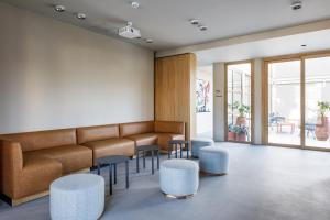 a waiting room with a bench and stools at Bromelia Hotel Boutique in Buenos Aires