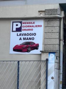 a sign on the side of a building with a red car at Luxury Boutique Hotel in Rome