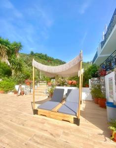 a hammock bed on a patio with a view at SKIATHOS-FILOKALIA in Achladies