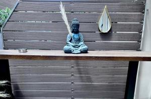 a statue sitting on top of a bench with a mirror at Phoenix Garden Apartment I in Athens