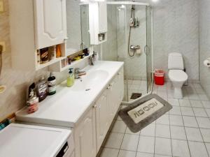 a bathroom with a sink and a shower and a toilet at 4 person holiday home in Selje in Selje