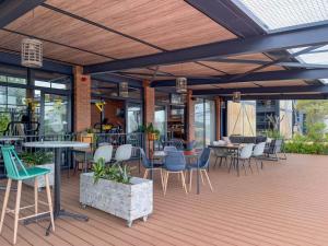 an outdoor patio with chairs and tables and windows at Crystal Lagoon Homes in Pretoria
