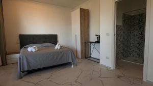 Ένα ή περισσότερα κρεβάτια σε δωμάτιο στο CconfortHotels Puglia Promenade Apartment 5